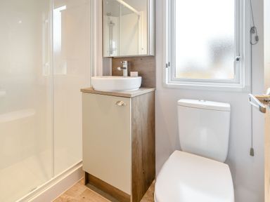 A bathroom with a shower, sink and toilet at Cedar Spa (Pet) Carlton Miniott near Thirsk