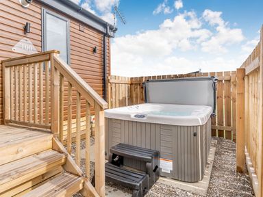 An outdoor area with a hot tub and steps at Kinder Spa in Carlton Miniott near Thirsk
