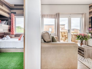 A living room and bedroom with furniture at Kinder Spa Carlton Miniott near Thirsk