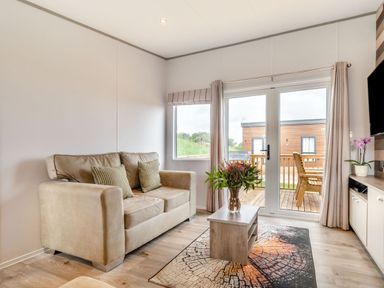 A living room with a sofa and table at Kinder Spa in Carlton Miniott near Thirsk