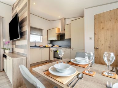 A kitchen with dining table setup at Kinder Spa in Carlton Miniott near Thirsk