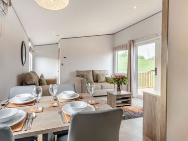 A dining room with a table set for dinner at Kinder Spa in Carlton Miniott near Thirsk