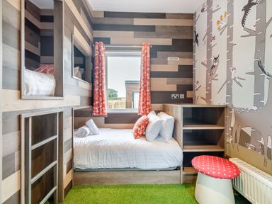 A bedroom with bunk beds and a window at Kinder Spa in Carlton Miniott near Thirsk