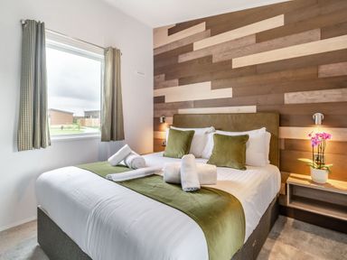 A bedroom with a bed and window at Kinder Spa Carlton Miniott near Thirsk