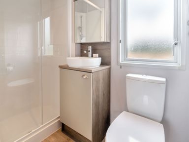 A bathroom with a shower, sink, and toilet at Kinder Spa in Carlton Miniott near Thirsk