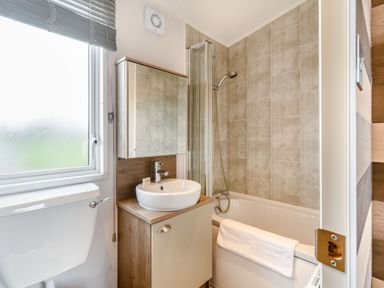 A bathroom with a sink, shower, and bathtub at Kinder Spa in Carlton Miniott near Thirsk