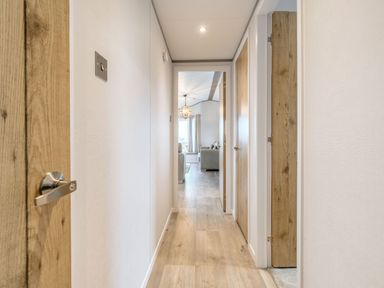 A hallway with doors leading to rooms at Oak Waterside Spa Carlton Miniott near Thirsk