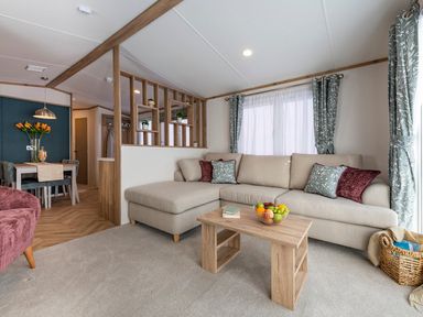 A living room with a sofa and coffee table at Redwood Waterside Spa Carlton Miniott near Thirsk