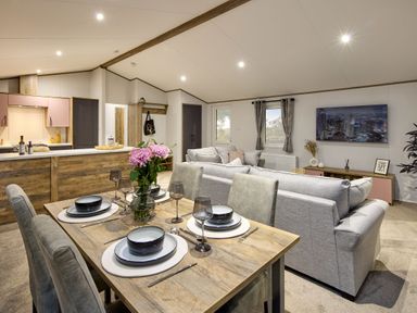 A living room with a dining table and sofa at Laurel Spa in Carlton Miniott near Thirsk