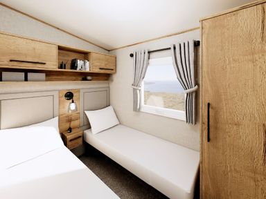 A bedroom with a bed and a wardrobe at Willow Spa Carlton Miniott near Thirsk