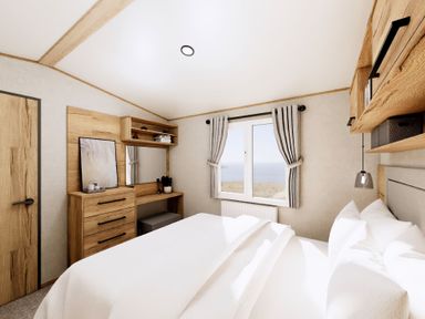 A bedroom with a bed and storage furniture at Willow Spa (Pet) Carlton Miniott near Thirsk