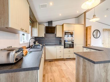 A kitchen with a sink and toaster at Spindle Spa Carlton Miniott near Thirsk