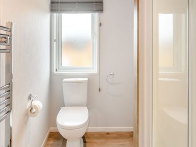 A bathroom featuring a toilet and a shower at Spindle Spa Carlton Miniott near Thirsk