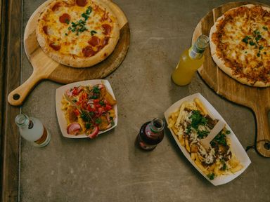 A pizza and fries on a table at Spindle Spa Carlton Miniott near Thirsk