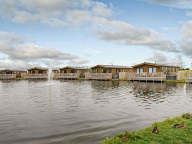 A view of lodges by the water at Larch Waterside Spa Carlton Miniott near Thirsk