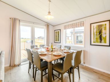 A dining room with a table set for a meal at Beech Waterside Spa Carlton Miniott near Thirsk