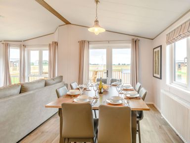 A dining room with a table set at Beech Waterside Spa Carlton Miniott near Thirsk