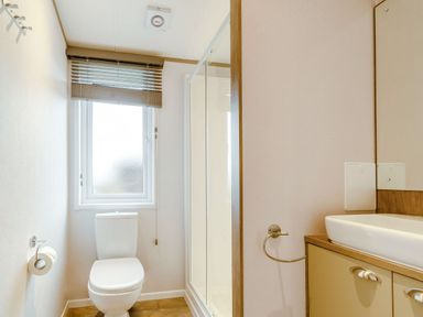 A bathroom with a toilet and sink at Beech Waterside Spa, Carlton Miniott near Thirsk