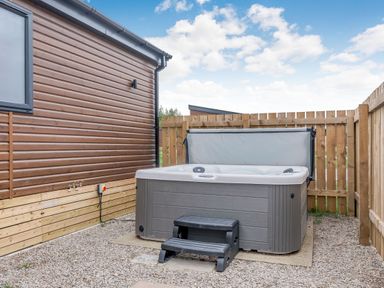 An outdoor space with a hot tub and steps at Beech Waterside Spa Carlton Miniott near Thirsk