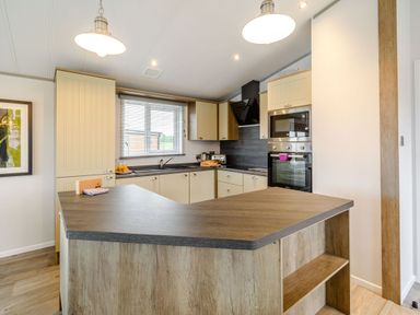 A kitchen with countertop and appliances at Beech Waterside Spa (Pet) Carlton Miniott near Thirsk
