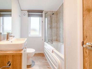 A bathroom with a sink and bath tub at Beech Waterside Spa (Pet) Carlton Miniott near Thirsk