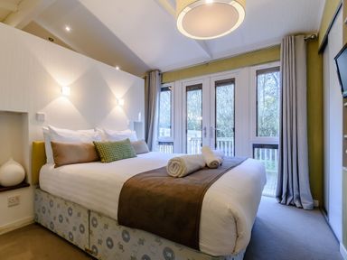 A bedroom with a bed and curtains at Cherry Tree in Carlton Miniott near Thirsk