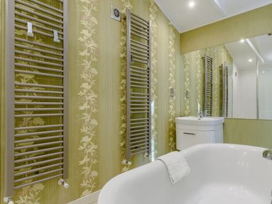 A bathroom with a bathtub and sink at Cherry Tree in Carlton Miniott near Thirsk