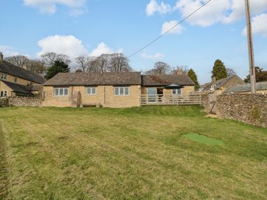 A house with a grassy area and a patio at Daisy Bank in Maugersbury near Stow-On-The-Wold
