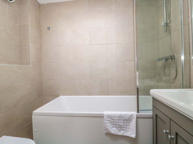 A bathroom with a bathtub and shower at Daisy Bank Maugersbury near Stow-On-The-Wold