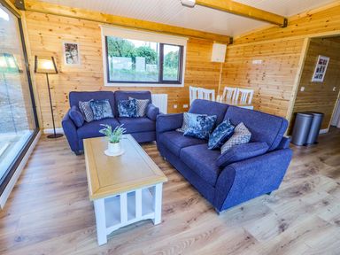 A living room with sofas and a coffee table at Killinure Cottage in Glasson, County Westmeath