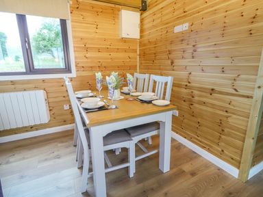 A dining room with table and chairs at Killinure Cottage in Glasson, County Westmeath