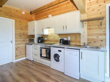 A kitchen with appliances including an oven and washing machine at Killinure Cottage Glasson, County Westmeath