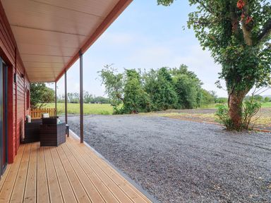 A porch with seating and gravel area at Killinure Cottage in Glasson, County Westmeath