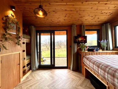 A bedroom with a bunk bed and a bed at Harriet in Llangurig