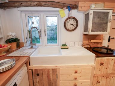 A kitchen with a sink and window at The Hare & the Bumblebee Cottage