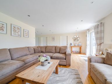 A living room with a sofa and coffee table at Aspen Lodge Near Brigg