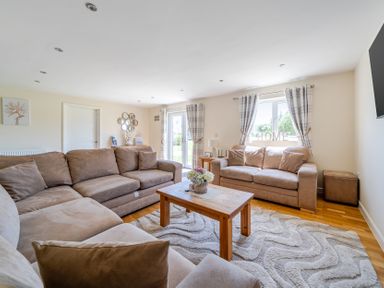 A living room with a sofa and coffee table at Aspen Lodge Near Brigg