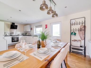 A dining room with a wooden table and chairs at Aspen Lodge near Brigg