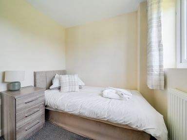 A bedroom with a bed and bedside table at Aspen Lodge Near Brigg