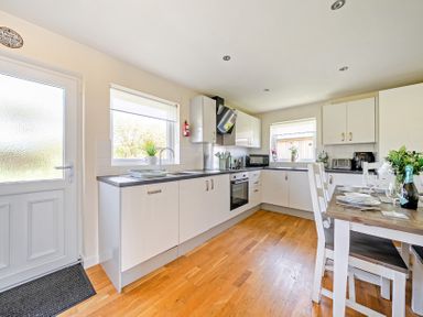 A kitchen with a dining table and appliances at Sage Lodge Near Brigg