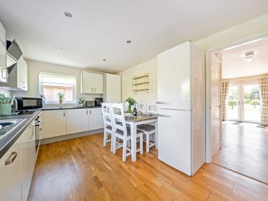 A kitchen with a dining table and chairs at Sage Lodge Near Brigg