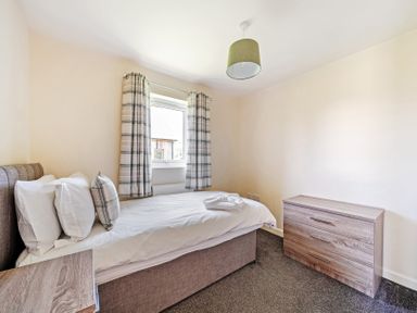 A bedroom with a bed and window at Sage Lodge Near Brigg