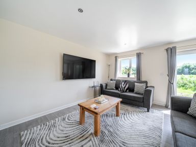 A living room with a sofa and coffee table at Raven Lodge Near Brigg
