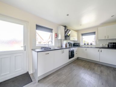 A kitchen with cabinets and appliances at Raven Lodge Near Brigg
