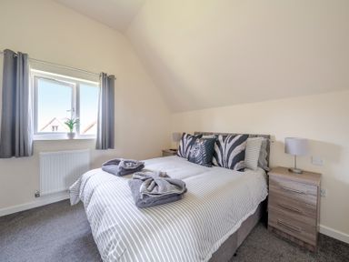 A bedroom with a bed and bedside table at Raven Lodge Near Brigg