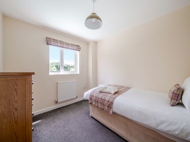 A bedroom with a bed and window at Paddington Lodge Near Brigg