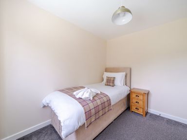 A bedroom with a bed and nightstand at Paddington Lodge near Brigg