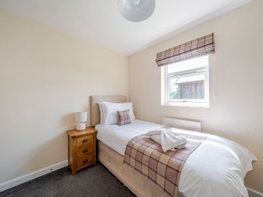 A bedroom with a single bed and bedside table at Paddington Lodge Near Brigg
