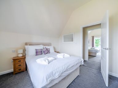 A bedroom with a bed and bedside table at Paddington Lodge near Brigg