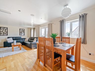 A living room with a dining area and sofa at Charcoal Lodge in Brigg